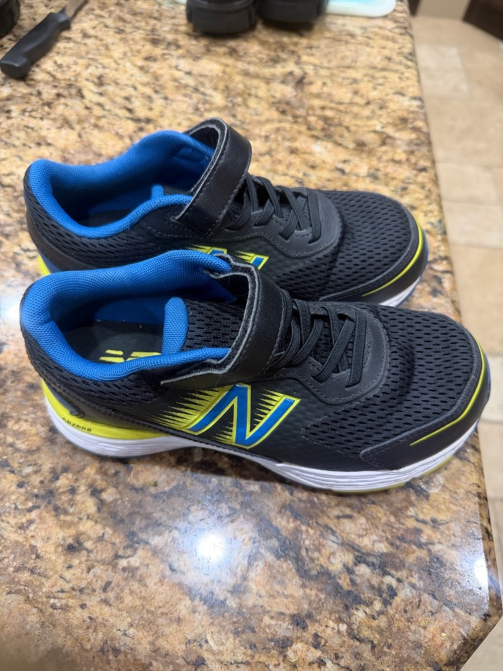 New Balance Black Sneakers with Blue and Yellow Accents